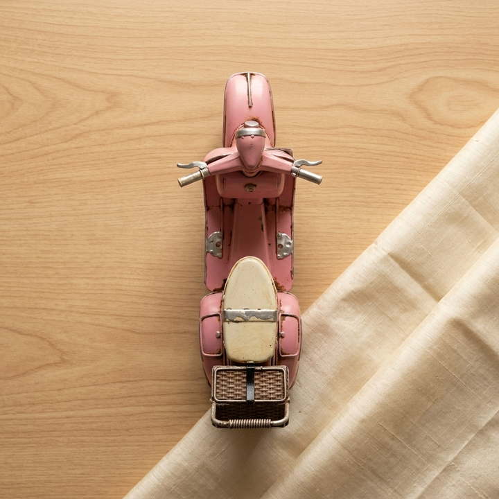 Blush pink scooter tabletop decor with decorative basket