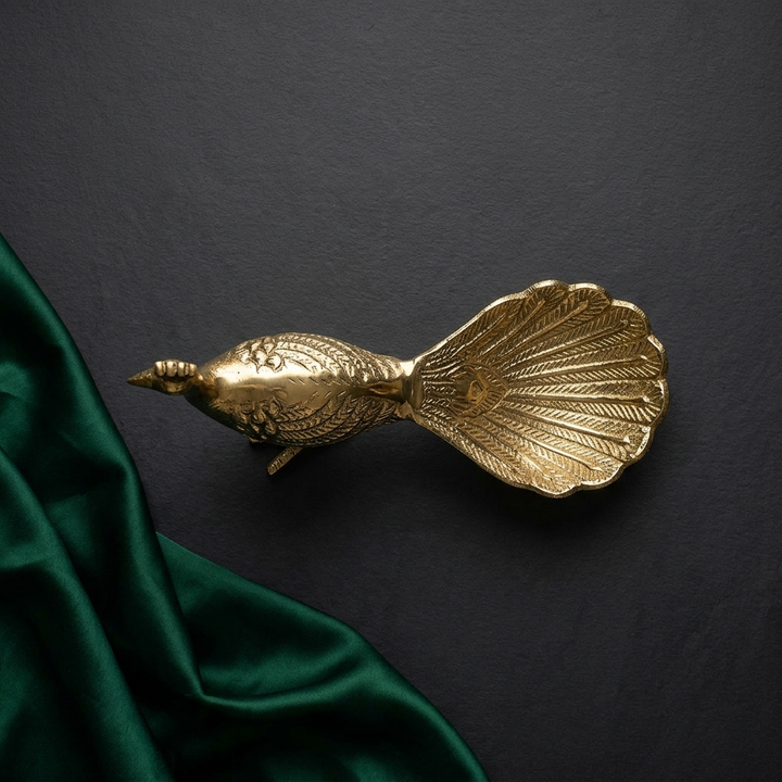 Antique gold peacock decorative key holder on console
