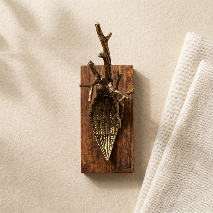 Artistic gold tree branch sculpture displayed on wooden base