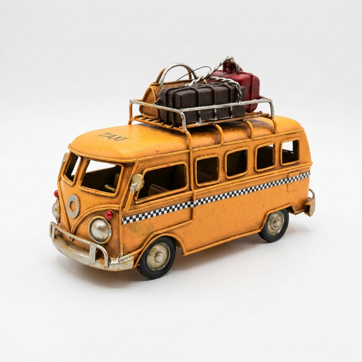 Vintage travel van showpiece in yellow with rooftop luggage