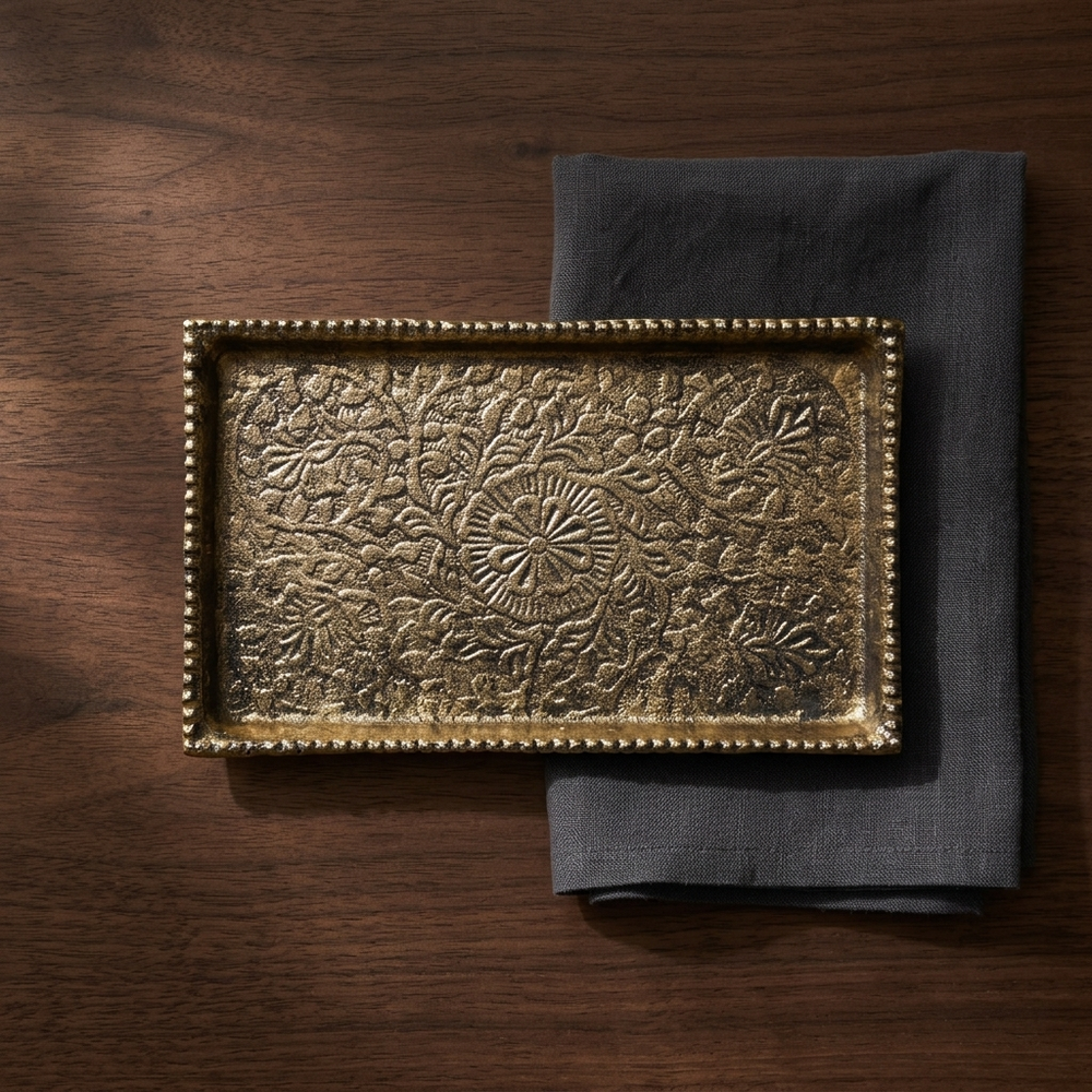 Gold decorative serving tray styled on wooden table