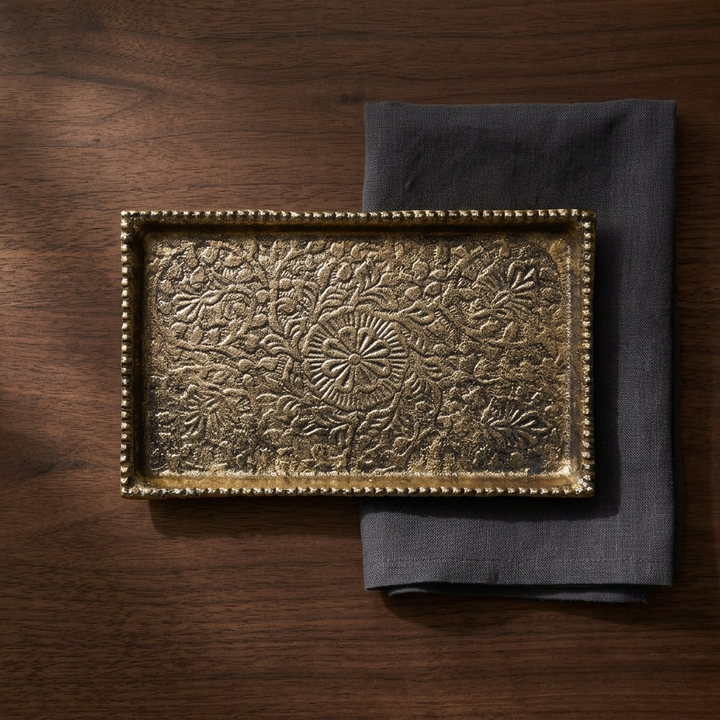 Gold decorative serving tray styled on wooden table