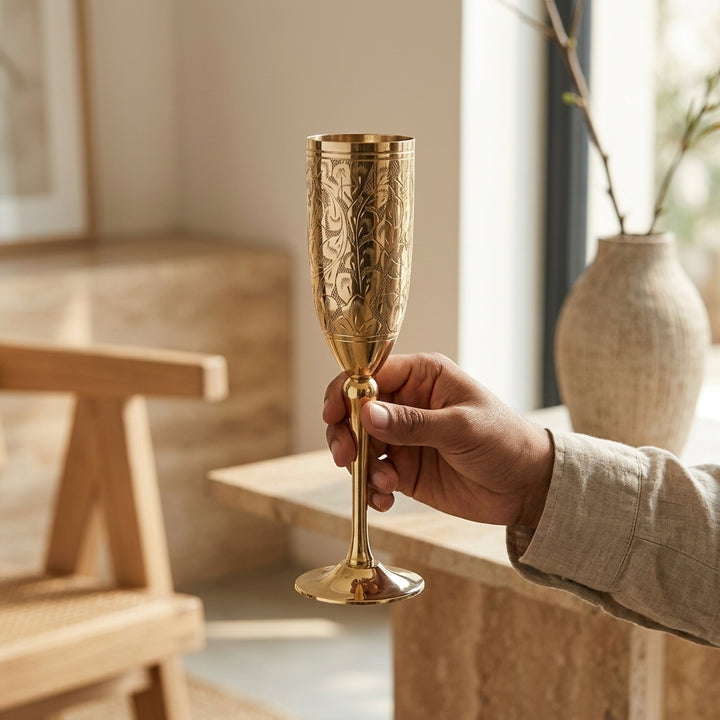 Engraved brass champagne flute with elegant floral detailing